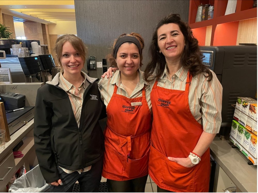 Divna smiles with her co-workers in their Coffee Flats aprons